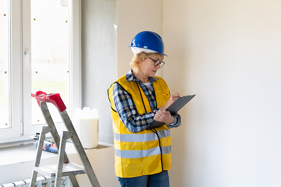 woman construction worker inspects the building