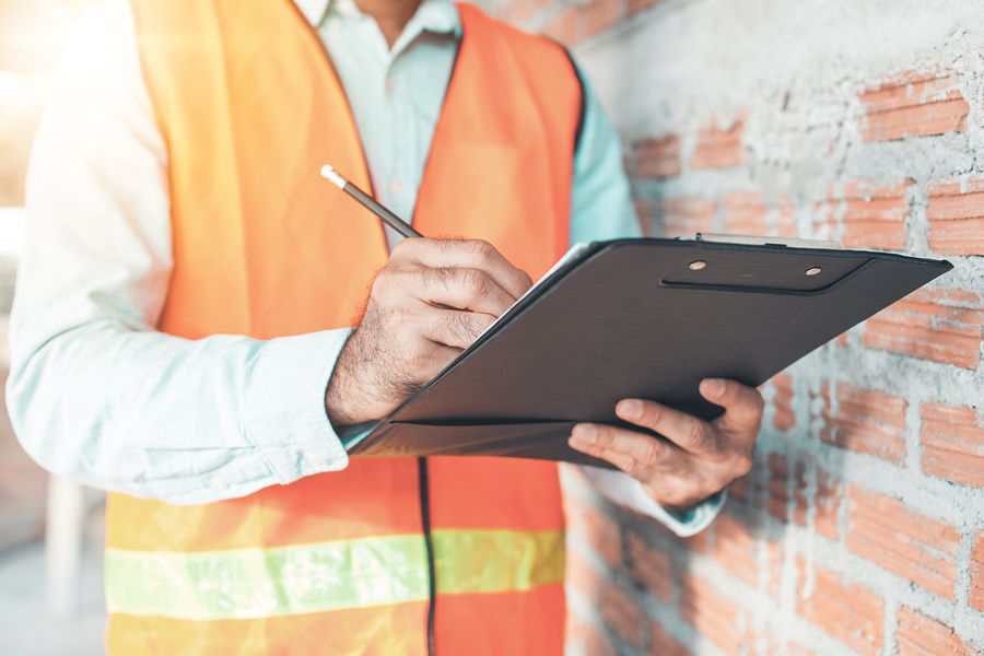 inspector checking progressing work in construction site